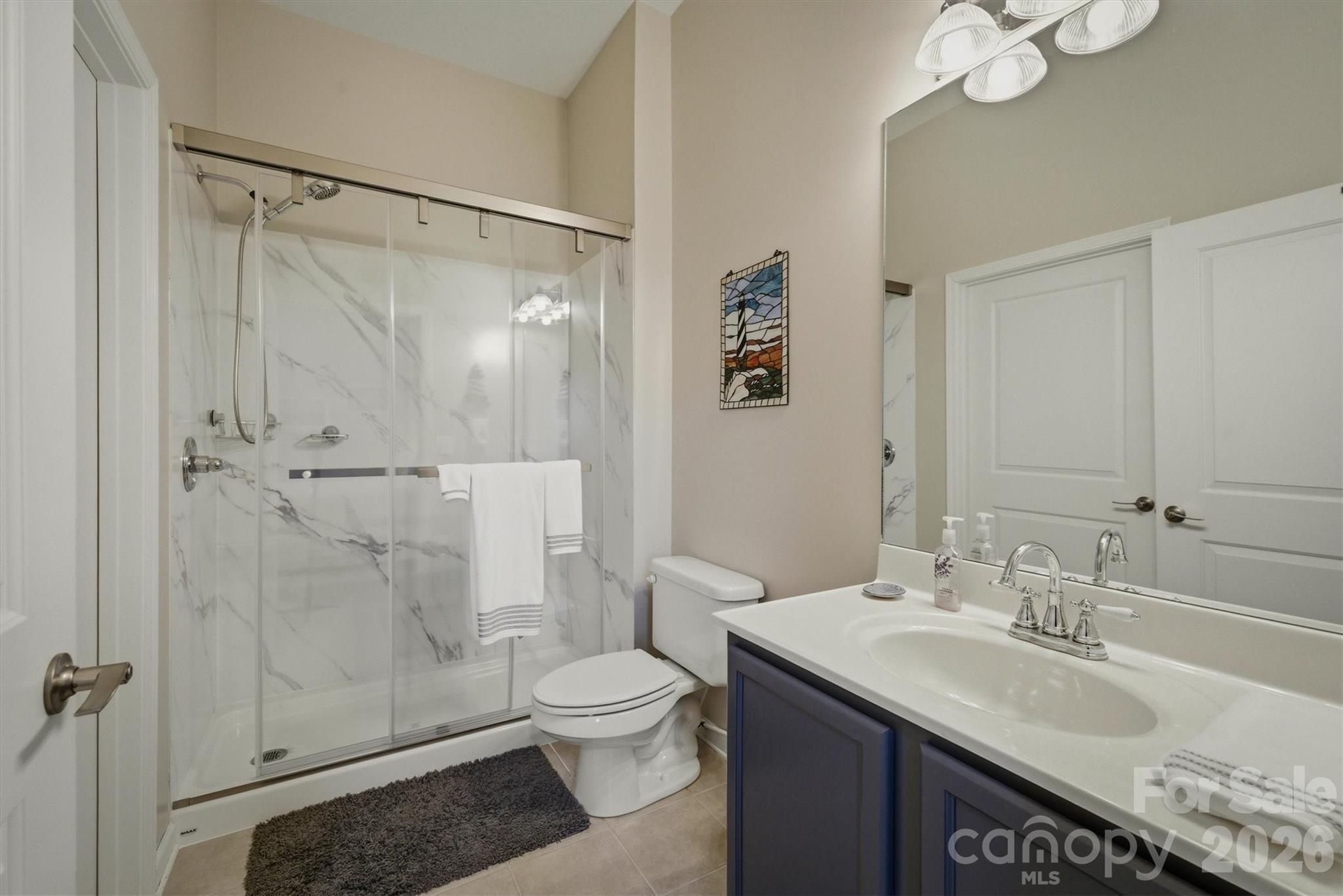 406 East Union Street Morganton, NC 28655 - Photo 15 of 23 a bathroom with a granite countertop sink toilet and shower