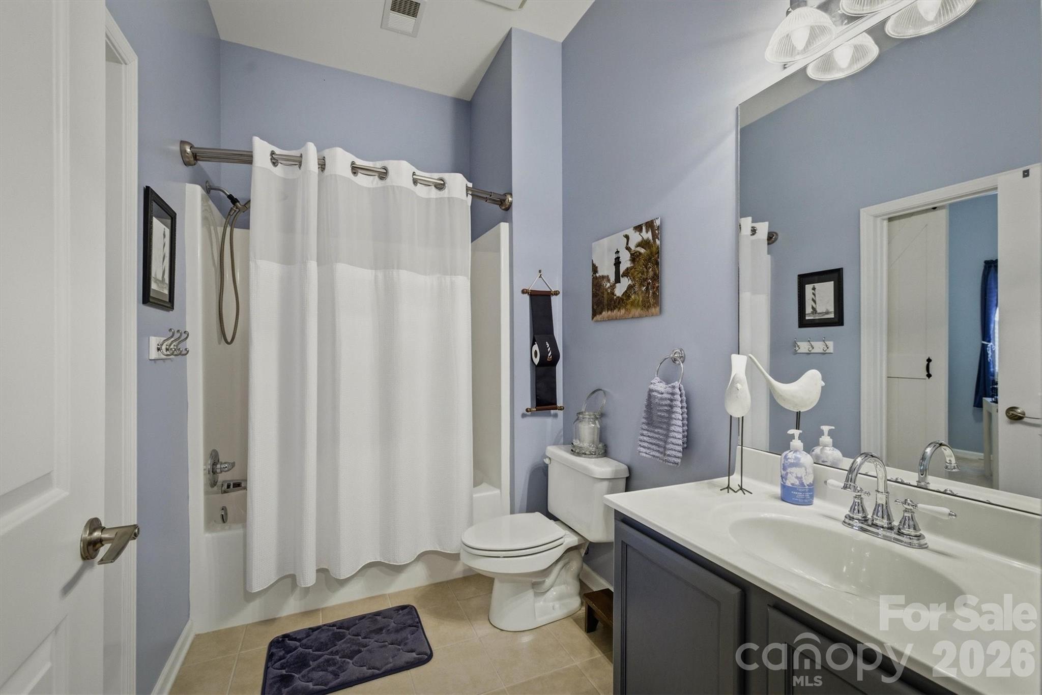 406 East Union Street Morganton, NC 28655 - Photo 17 of 23 a bathroom with a granite countertop sink toilet and shower