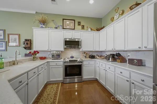 a kitchen with cabinets appliances and a sink