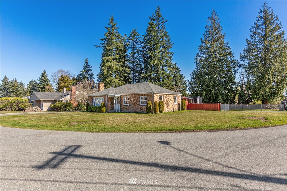 7011 Cady Road Everett, WA 98203 - Photo 2 of 32 a front view of a house with a yard and trees