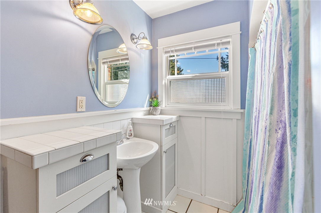 7011 Cady Road Everett, WA 98203 - Photo 12 of 32 a bathroom with a sink and a mirror