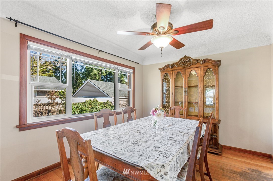 7011 Cady Road Everett, WA 98203 - Photo 14 of 32 a view of a dining room with furniture window and wooden floor