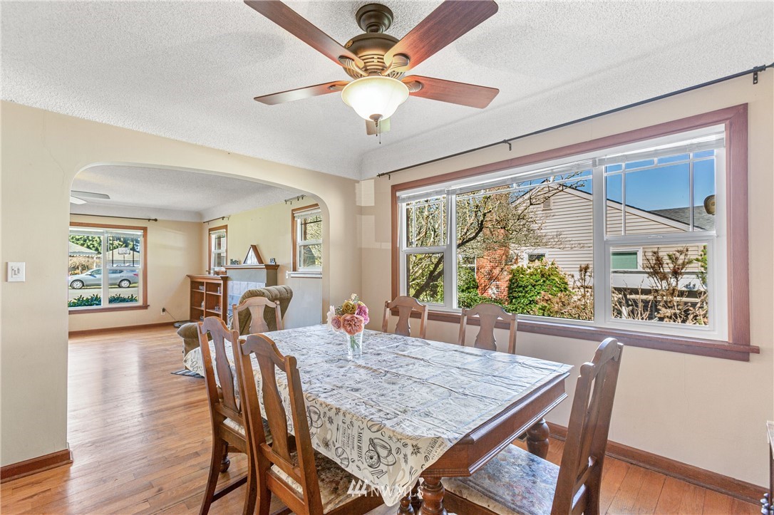 7011 Cady Road Everett, WA 98203 - Photo 23 of 32 a view of a dining room with furniture window and wooden floor
