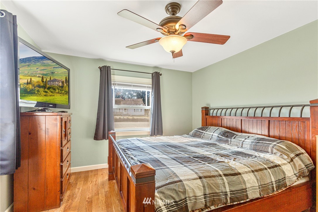7011 Cady Road Everett, WA 98203 - Photo 25 of 32 a bedroom with a bed and wooden floor