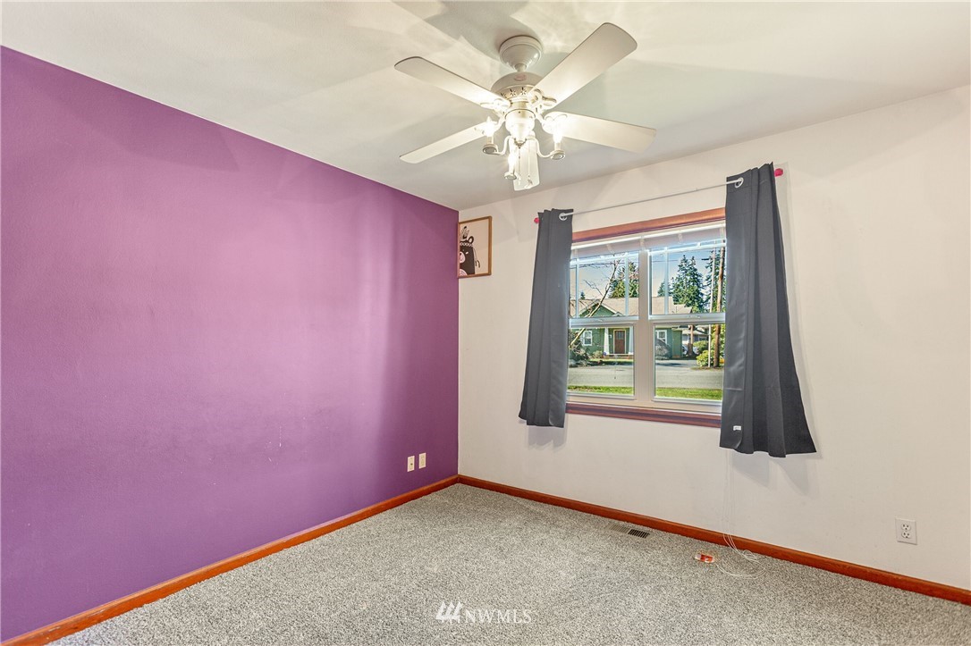 7011 Cady Road Everett, WA 98203 - Photo 26 of 32 an empty room with windows and fan