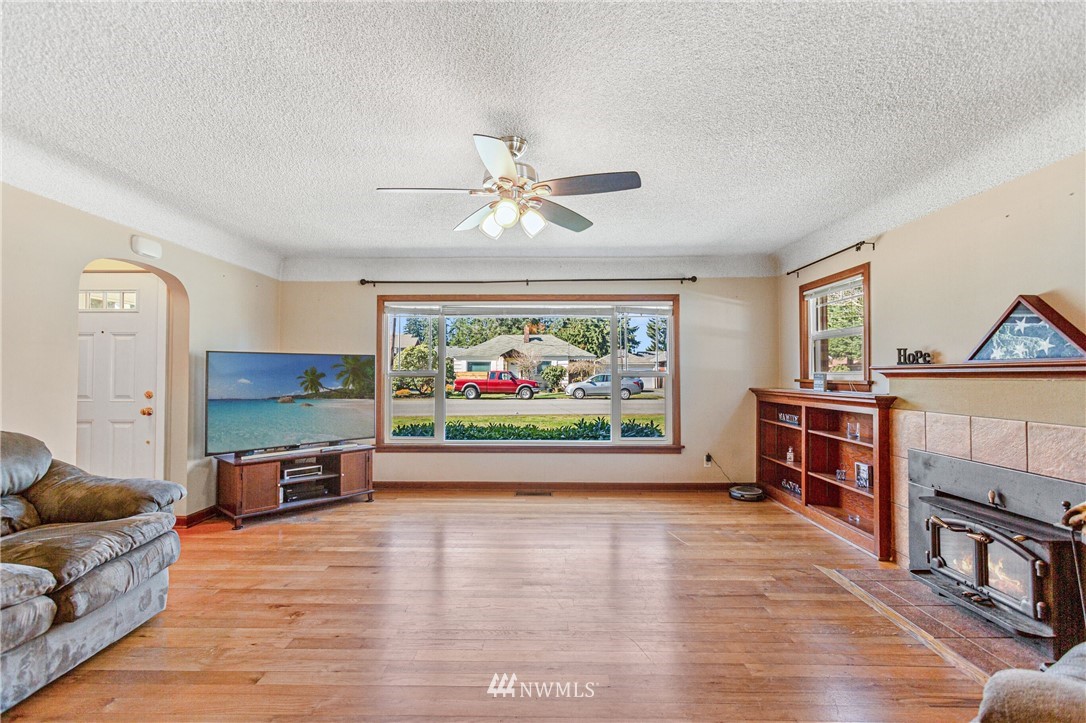 7011 Cady Road Everett, WA 98203 - Photo 6 of 32 a living room with furniture a window and a flat screen tv