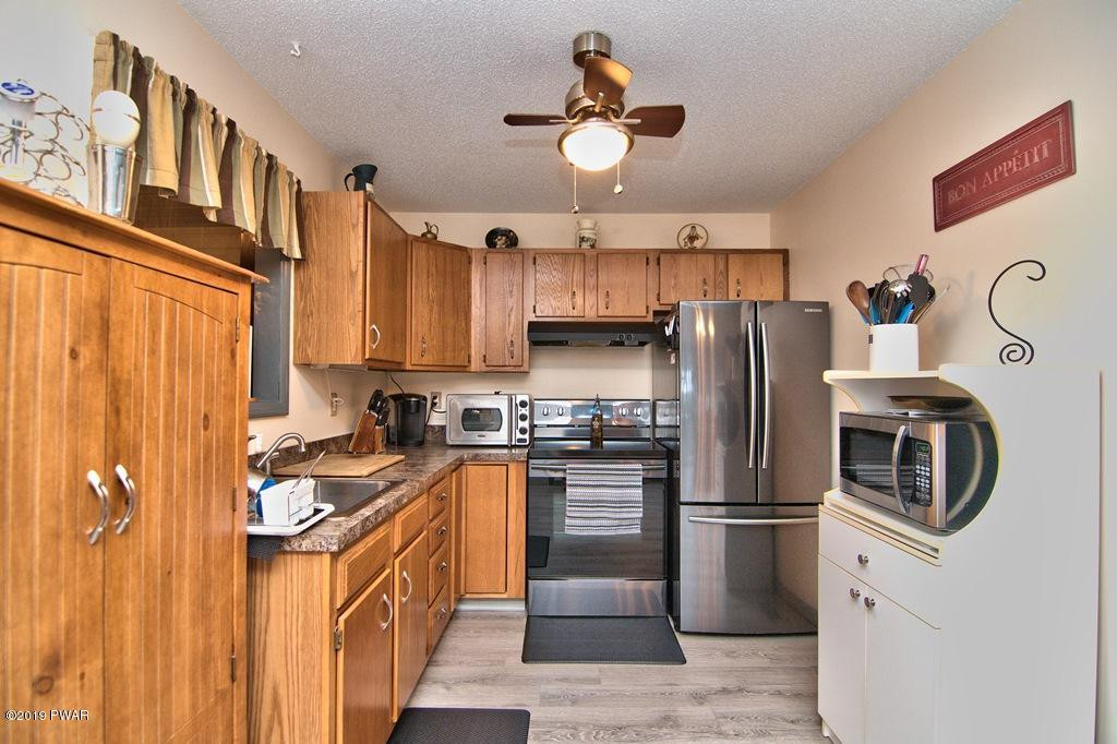 3151 Northgate Road Lake Ariel, PA 18436 - Photo 15 of 68 a kitchen with stainless steel appliances granite countertop a refrigerator a stove a sink and dishwasher