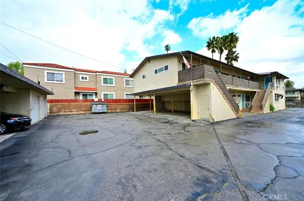a white toilet sitting next to a white bath tub