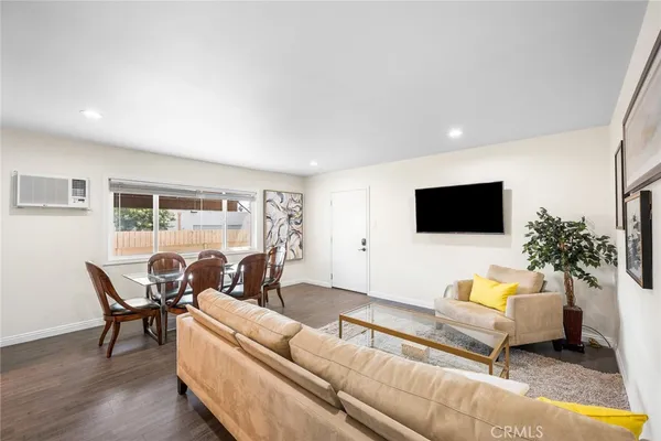 an empty room with wooden floor and ceiling fan