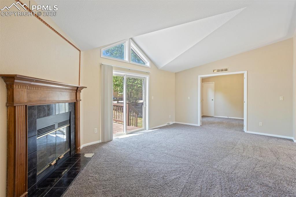 7765 Valley Quail Point Colorado Springs, CO 80922 - Photo 11 of 37 a view of empty room with floor to ceiling window and chandelier