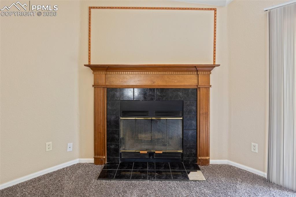 7765 Valley Quail Point Colorado Springs, CO 80922 - Photo 12 of 37 a living room with a fireplace