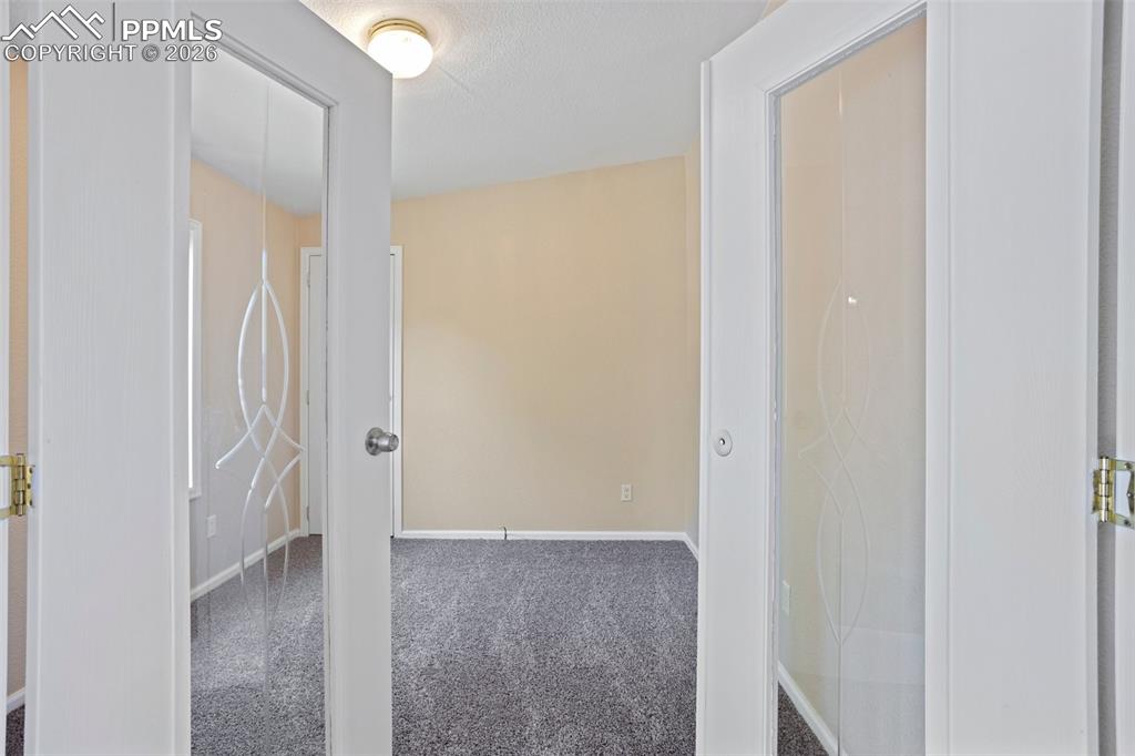 7765 Valley Quail Point Colorado Springs, CO 80922 - Photo 20 of 37 a view of a hallway with wooden floor