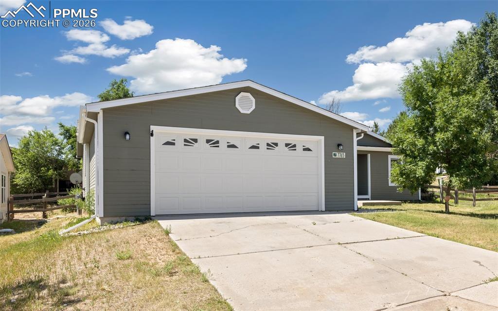 7765 Valley Quail Point Colorado Springs, CO 80922 - Photo 2 of 37 a front view of a house with a yard