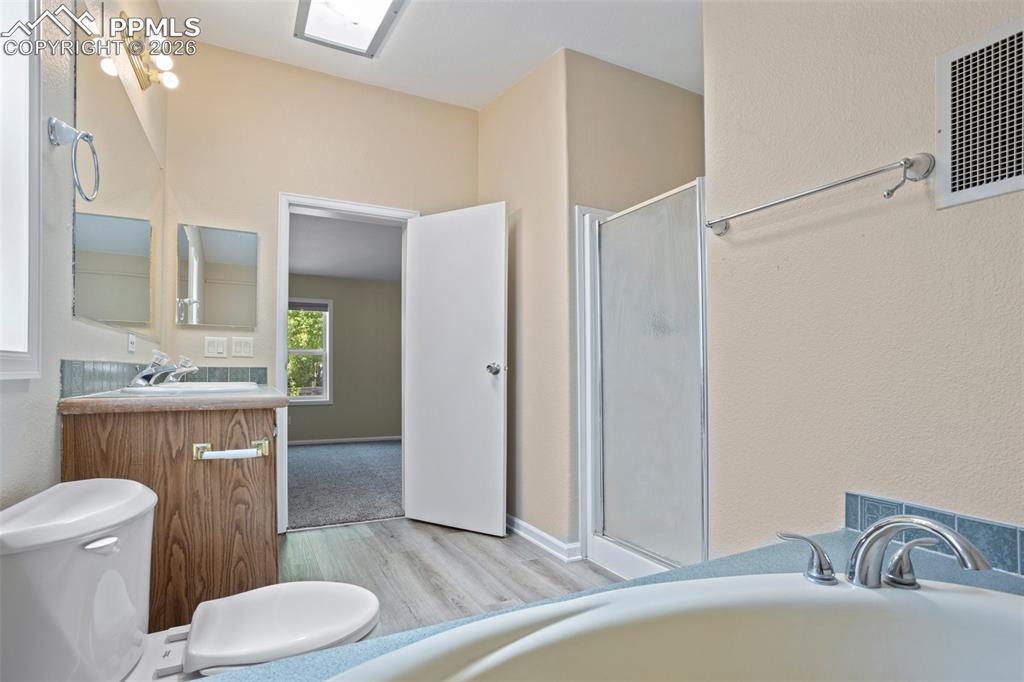 7765 Valley Quail Point Colorado Springs, CO 80922 - Photo 25 of 37 a bathroom with a granite countertop sink and a mirror
