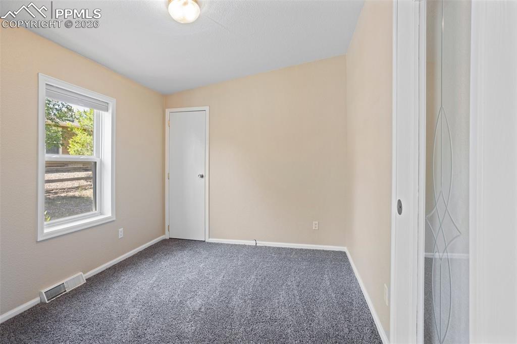 7765 Valley Quail Point Colorado Springs, CO 80922 - Photo 28 of 37 a view of an empty room with a window