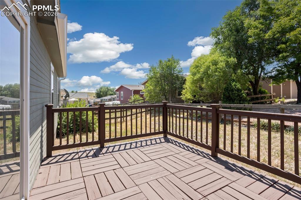7765 Valley Quail Point Colorado Springs, CO 80922 - Photo 30 of 37 a view of a balcony with wooden floor