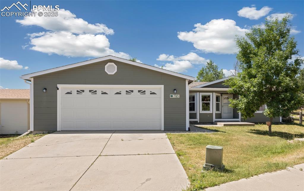 7765 Valley Quail Point Colorado Springs, CO 80922 - Photo 3 of 37 a front view of a house with garden