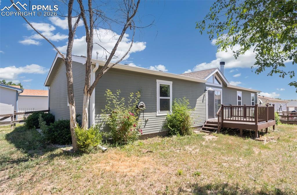 7765 Valley Quail Point Colorado Springs, CO 80922 - Photo 36 of 37 a view of a house with a yard
