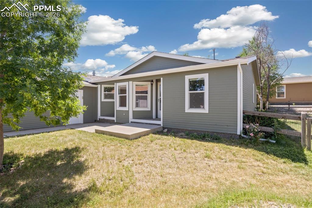 7765 Valley Quail Point Colorado Springs, CO 80922 - Photo 4 of 37 a view of a house with a yard and potted plants