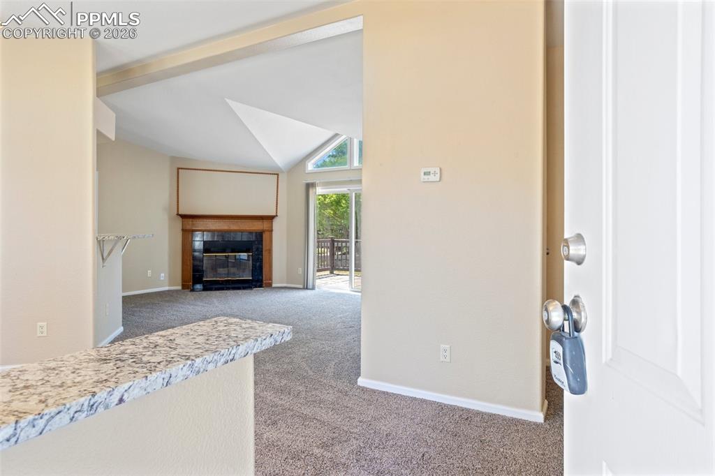 7765 Valley Quail Point Colorado Springs, CO 80922 - Photo 5 of 37 a view of living room with furniture and a fireplace