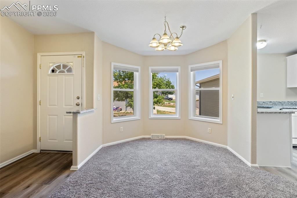 7765 Valley Quail Point Colorado Springs, CO 80922 - Photo 6 of 37 a view of an empty room with a window