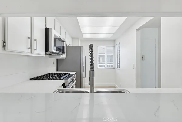a kitchen with stainless steel appliances granite countertop a refrigerator and cabinets