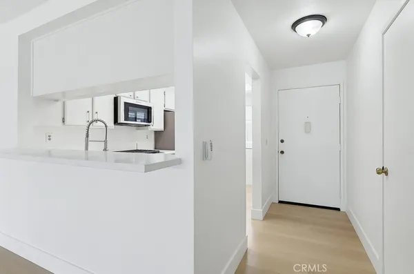 a view of a kitchen with sink and natural light