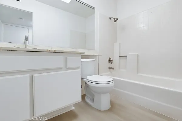 a bathroom with a toilet and a bathtub