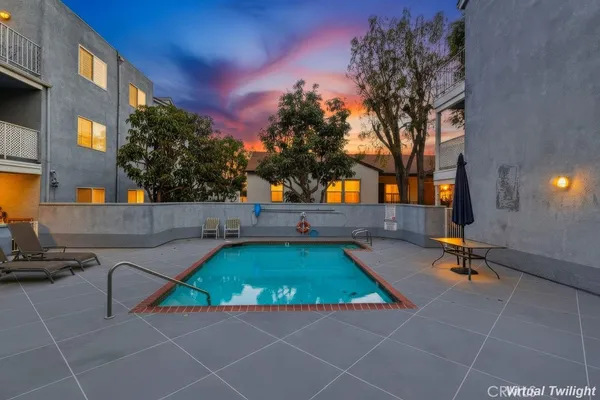 a view of a swimming pool with an outdoor seating