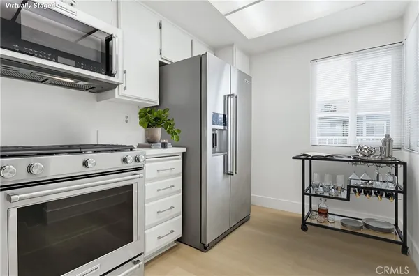 a kitchen with appliances cabinets and a window