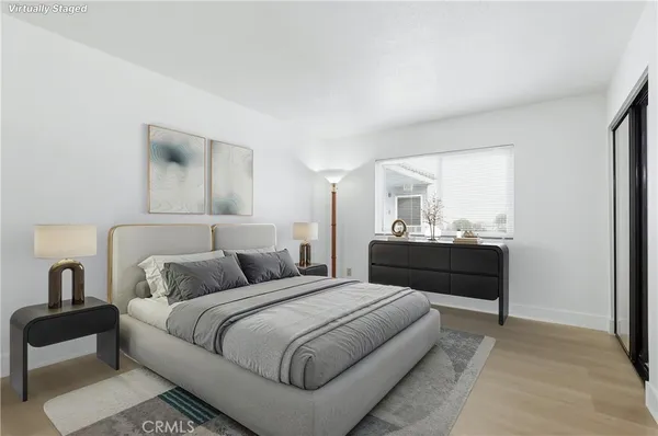 a bedroom with a bed and a mirror