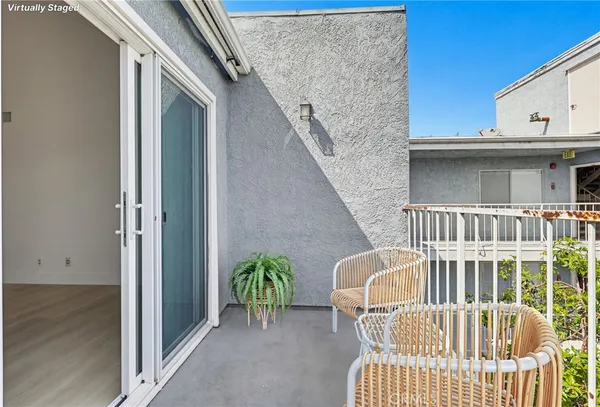 a balcony with table and chairs