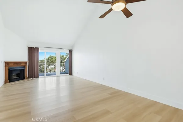 a view of empty room with fireplace and fan