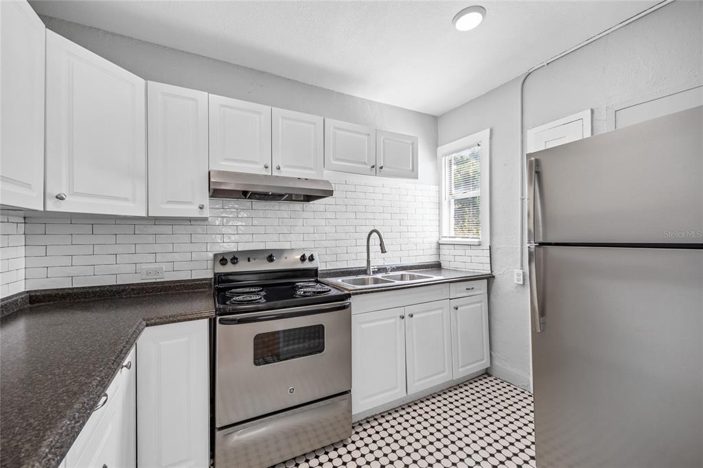 3205 West San Pedro Street, Unit 1 Tampa, FL 33629 - Photo 11 of 35 a kitchen with cabinets stainless steel appliances and a sink