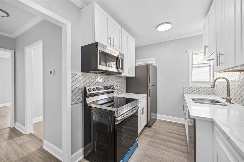 3205 West San Pedro Street, Unit 1 Tampa, FL 33629 - Photo 12 of 35 a kitchen with stainless steel appliances granite countertop a refrigerator stove and sink