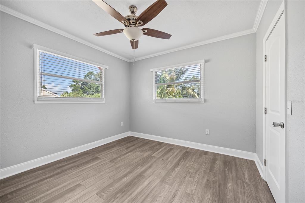 3205 West San Pedro Street, Unit 1 Tampa, FL 33629 - Photo 15 of 35 a view of an empty room with wooden floor and a ceiling fan