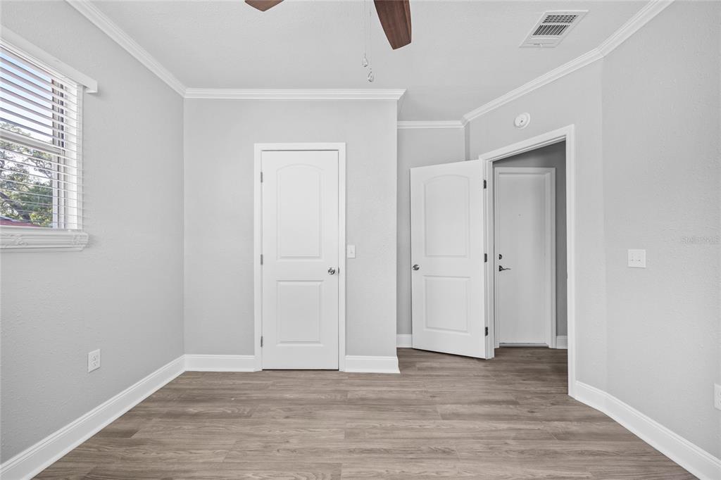 3205 West San Pedro Street, Unit 1 Tampa, FL 33629 - Photo 16 of 35 a view of an empty room with wooden floor and a window