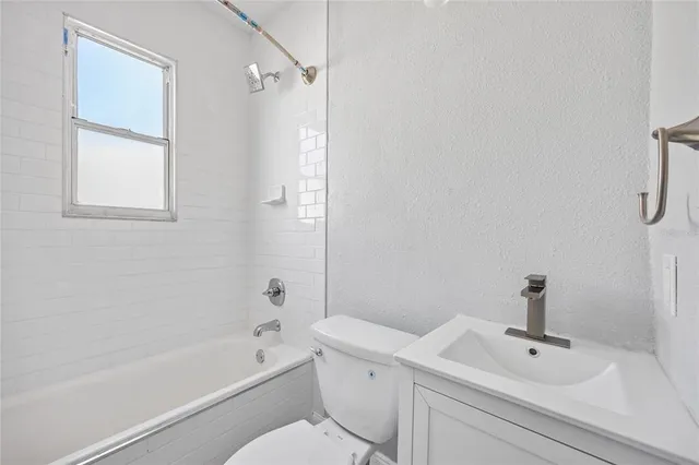 a view of empty room with wooden floor and window
