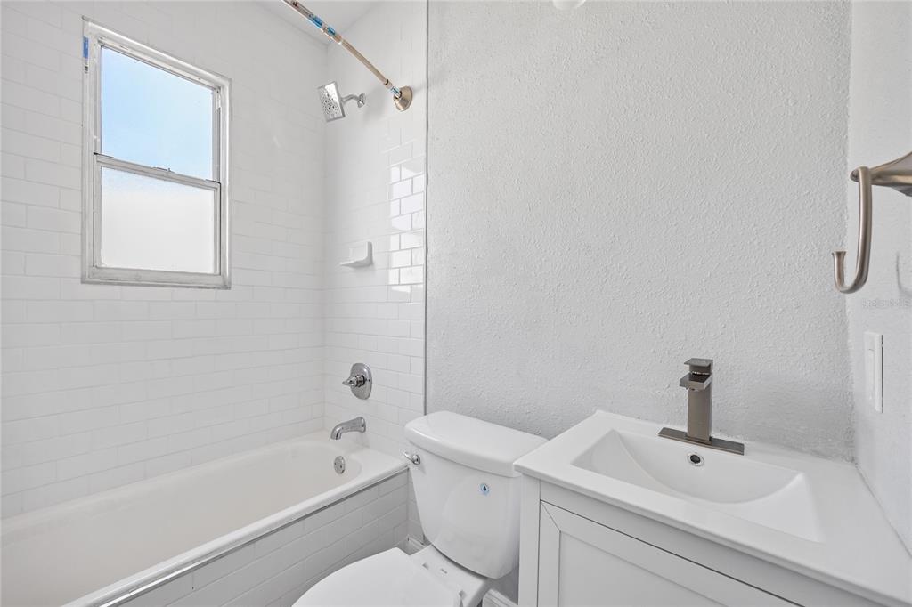 3205 West San Pedro Street, Unit 1 Tampa, FL 33629 - Photo 17 of 35 a bathroom with a white bath tub a sink and a mirror