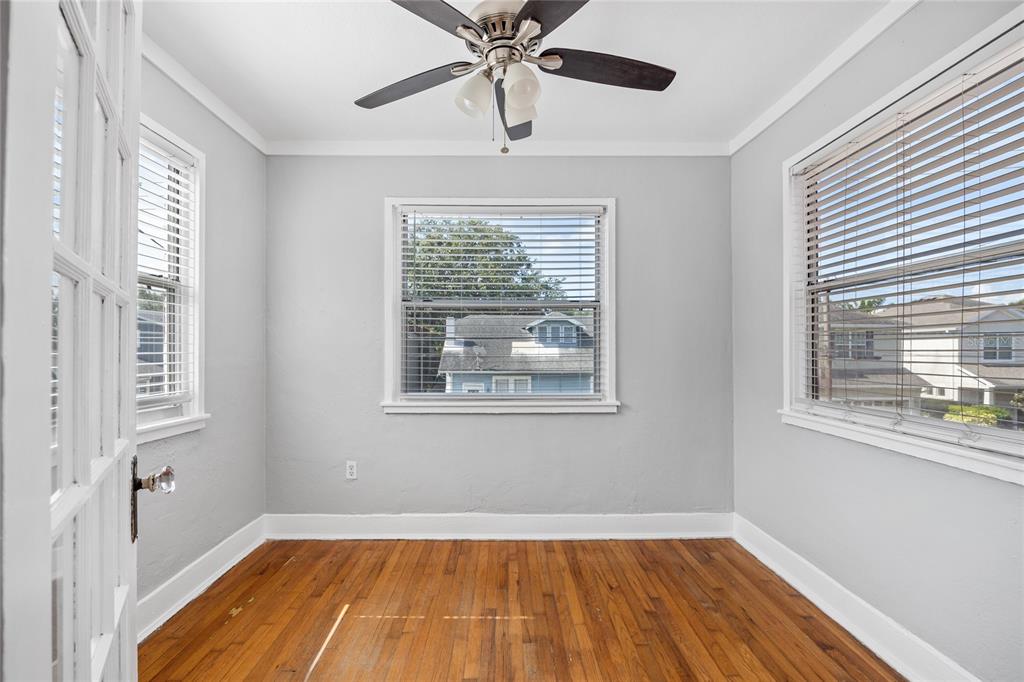 3205 West San Pedro Street, Unit 1 Tampa, FL 33629 - Photo 23 of 35 a view of an empty room with wooden floor and a window