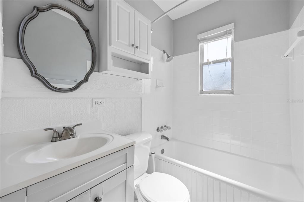 3205 West San Pedro Street, Unit 1 Tampa, FL 33629 - Photo 24 of 35 a bathroom with a sink a toilet and a mirror