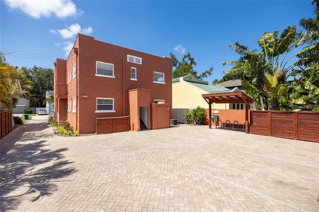 a yellow house with trees in front of it