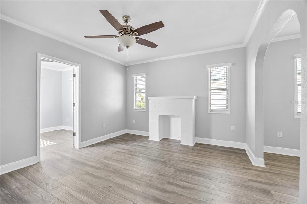 3205 West San Pedro Street, Unit 1 Tampa, FL 33629 - Photo 7 of 35 an empty room with wooden floor a ceiling fan and windows