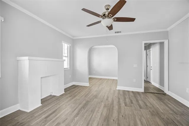 a view of an empty room with wooden floor
