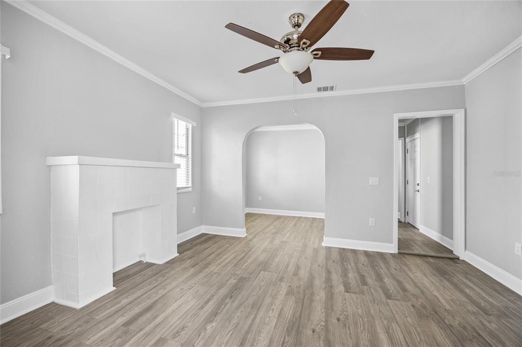 3205 West San Pedro Street, Unit 1 Tampa, FL 33629 - Photo 8 of 35 an empty room with wooden floor and a ceiling fan