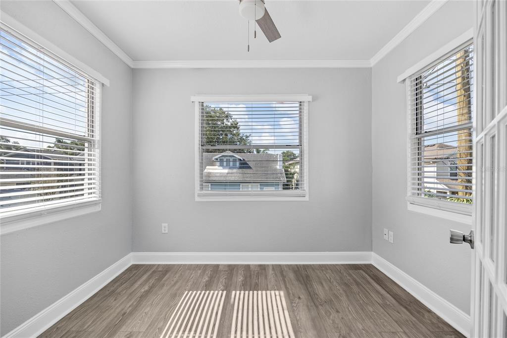 3205 West San Pedro Street, Unit 1 Tampa, FL 33629 - Photo 10 of 35 a view of an empty room with a window and wooden floor