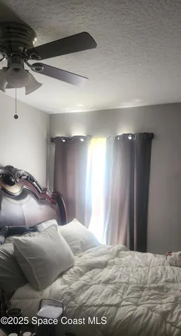 a bedroom with a bed and a mirror