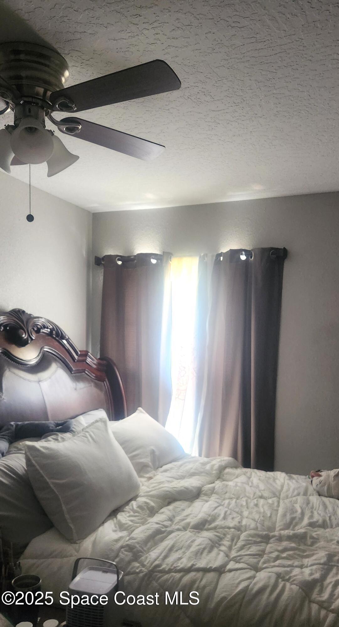 2014 Manor Drive Northeast Palm Bay, FL 32905 - Photo 11 of 15 a bedroom with a bed and a mirror