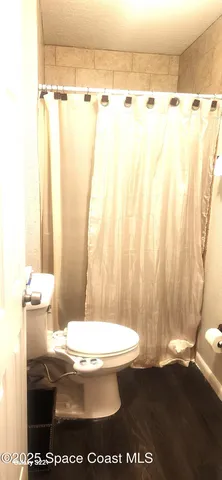 a bathroom with a toilet a sink and a shower