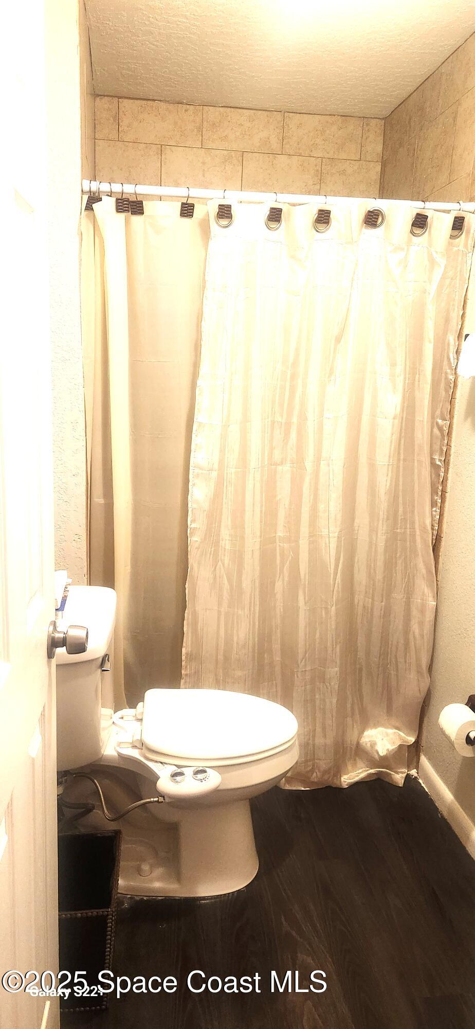 2014 Manor Drive Northeast Palm Bay, FL 32905 - Photo 13 of 15 a bathroom with a toilet a sink and a shower